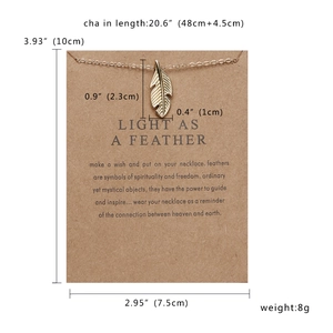 Detailed size specifications for the gold feather necklace on a brown kraft card