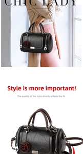 Detail of black vintage textured Boston bag featuring a red rose charm and strap