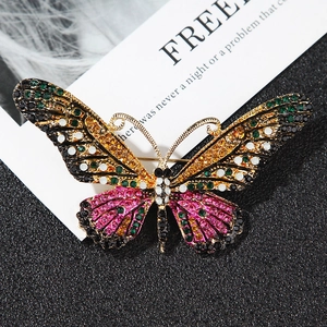 Close-up of colorful rhinestone butterfly brooch with intricate gold-tone wing details
