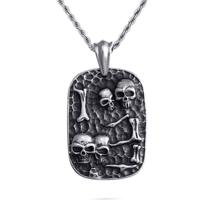 Punk style silver skull pendant necklace with relief details on a twisted rope chain