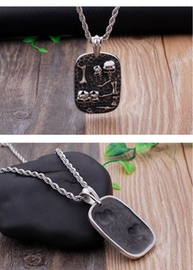 Detailed macro view showing the relief skull and bone design on punk metal pendant