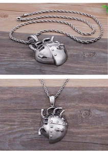 Macro detail of steampunk heart pendant with mechanical gears on a wooden surface