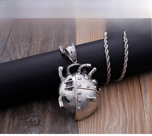 Macro shot of silver mechanical punk heart pendant with industrial gear details