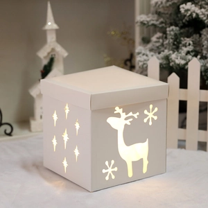 White Christmas light box with reindeer and snowflake cutouts for warm festive decor