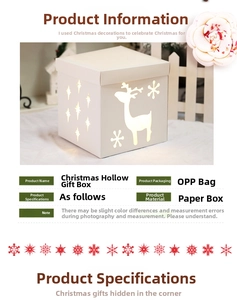 Macro shot of white cutout Christmas gift box with reindeer and snowflake paper patterns