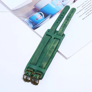 Vintage green wide leather bracelet with bronze metal buckles on a white background