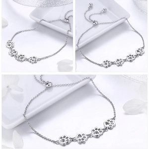 Detail of S925 sterling silver bracelet featuring hollow paw charms and adjustable clasp