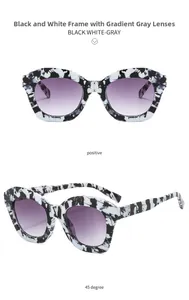 Detail view of cat eye sunglasses with black and white marble frame and gradient gray lenses