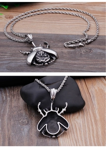 Detailed views of a beetle pendant with mechanical gear design on a silver chain