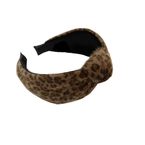 Fashionable plush leopard print knotted headband with a wide-brimmed design on white background