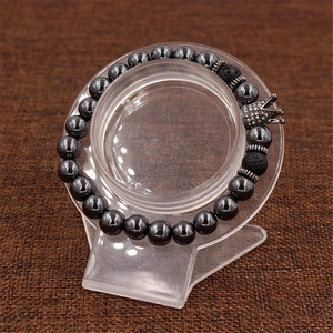 Macro view of beaded bracelet with black lava stones and sparkling crown charm