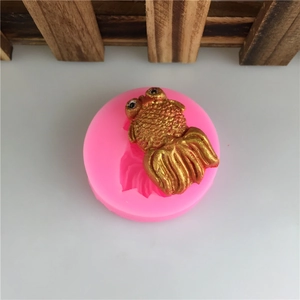 Pink silicone mold for 3D goldfish shapes used in fondant cake and chocolate baking