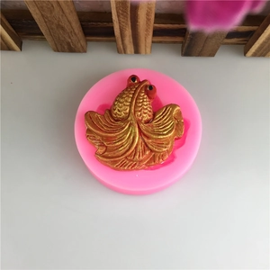 Pink silicone mold featuring detailed goldfish shape for fondant cakes and chocolate decorating