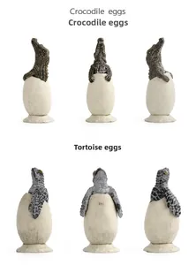 Detailed close-up of realistic crocodile and tortoise hatching egg models with bases