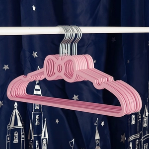 Close-up of pink non-slip plastic hangers with bow design and sturdy metal hooks