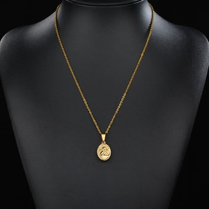 Minimalist gold stainless steel necklace featuring an oval Cupid angel pendant on black bust