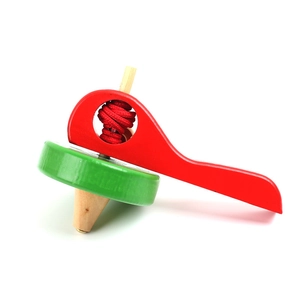Classic wooden spinning top toy with red handle and green disc on a white background
