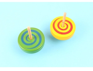 Top view of two colorful wooden spinning tops with spiral patterns on blue background