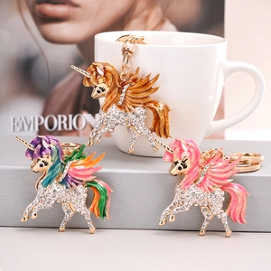 Macro detail of unicorn keychains with sparkling crystals and colorful enamel wings