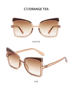 Detail view of butterfly sunglasses with tea-colored frames and brown gradient lenses