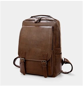 Detail of dark brown PU leather backpack featuring metal buckles and retro texture