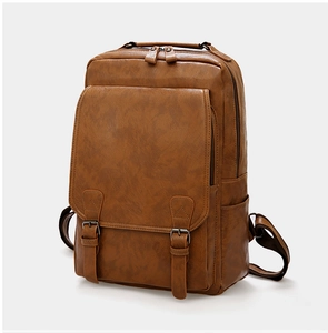 Detailed view of brown vintage PU leather backpack with dual strap buckle closures