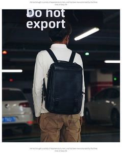Rear view of a man carrying a matte black PU leather business backpack in an urban setting