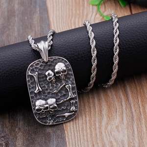 Punk rock skull rectangular dog tag pendant necklace with twisted chain on wood background