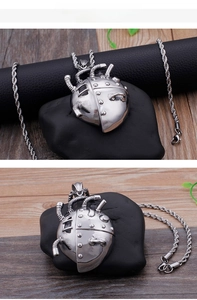 Detailed view of silver steampunk mechanical heart pendant with rope chain necklace