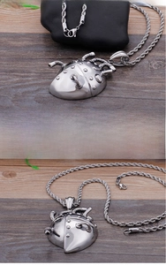 Macro shot of industrial mechanical heart pendant with metallic rivets and pipe details