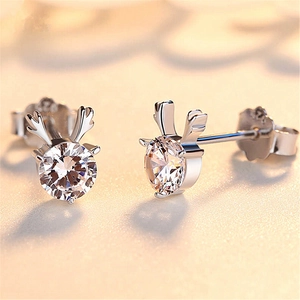 Macro shot of silver reindeer stud earrings featuring sparkling cubic zirconia stones