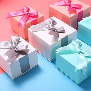 Square jewelry gift boxes with satin bows in pink, white, and light blue colors