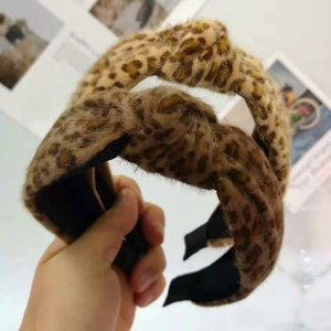 Detail of plush leopard print headbands featuring a stylish knotted bow design