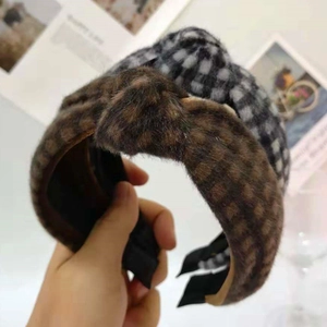 Close-up of plush knotted headbands with brown and black checkered patterns