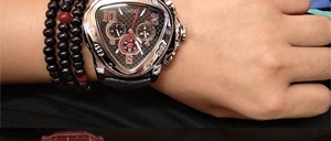 Wrist shot of a triangle automatic watch with silver case and black leather strap