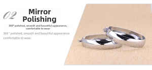 Detailed view of mirror polished wide silver hoop earrings with smooth metal surface