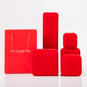 Detail of red velvet jewelry boxes and matching gift bags with Love For You text