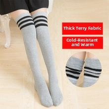 Detailed view of thickened terry lining for warmth on grey striped over-knee socks