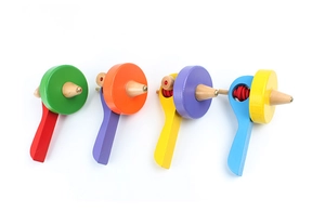 Set of four colorful wooden spinning tops with pull strings for children's educational play