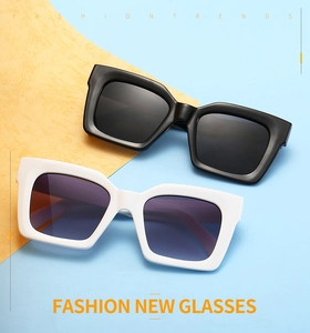 Detail of vintage thick frame square sunglasses with triple rivets in black and white