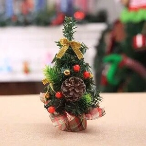 Close-up of 20cm mini Christmas tree with gold glitter bow and pinecone detail