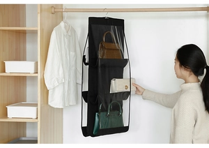 Vertical hanging handbag organizer in a closet featuring clear PVC dustproof pockets