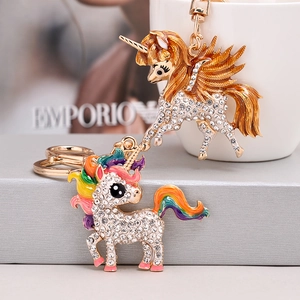 Detail of unicorn keychains with sparkling crystals and colorful enamel on metal