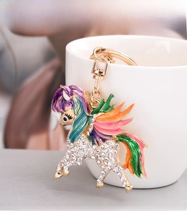 Detail shot of a unicorn keychain featuring colorful oil-dripping finish and sparkling rhinestones
