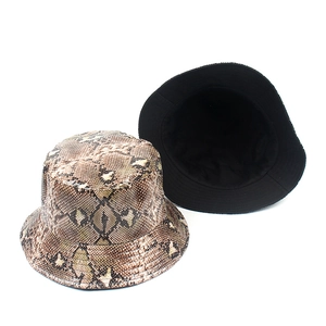 Reversible bucket hat featuring brown snakeskin print and black lining for street fashion
