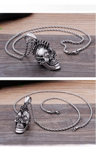 Macro shot of mechanical skull pendant with gear details and twisted chain