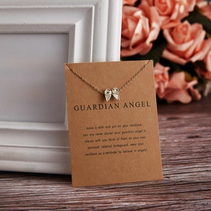 Detailed view of a golden angel wing necklace displayed on a Guardian Angel card