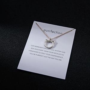 Detail of silver cat ear pendant necklace on an inspirational white card display