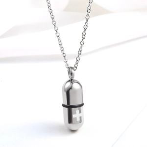 Polished stainless steel capsule pendant necklace with cross design on silver link chain