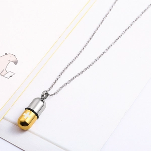 Two-tone stainless steel capsule pill pendant necklace with white cross on gold finish
